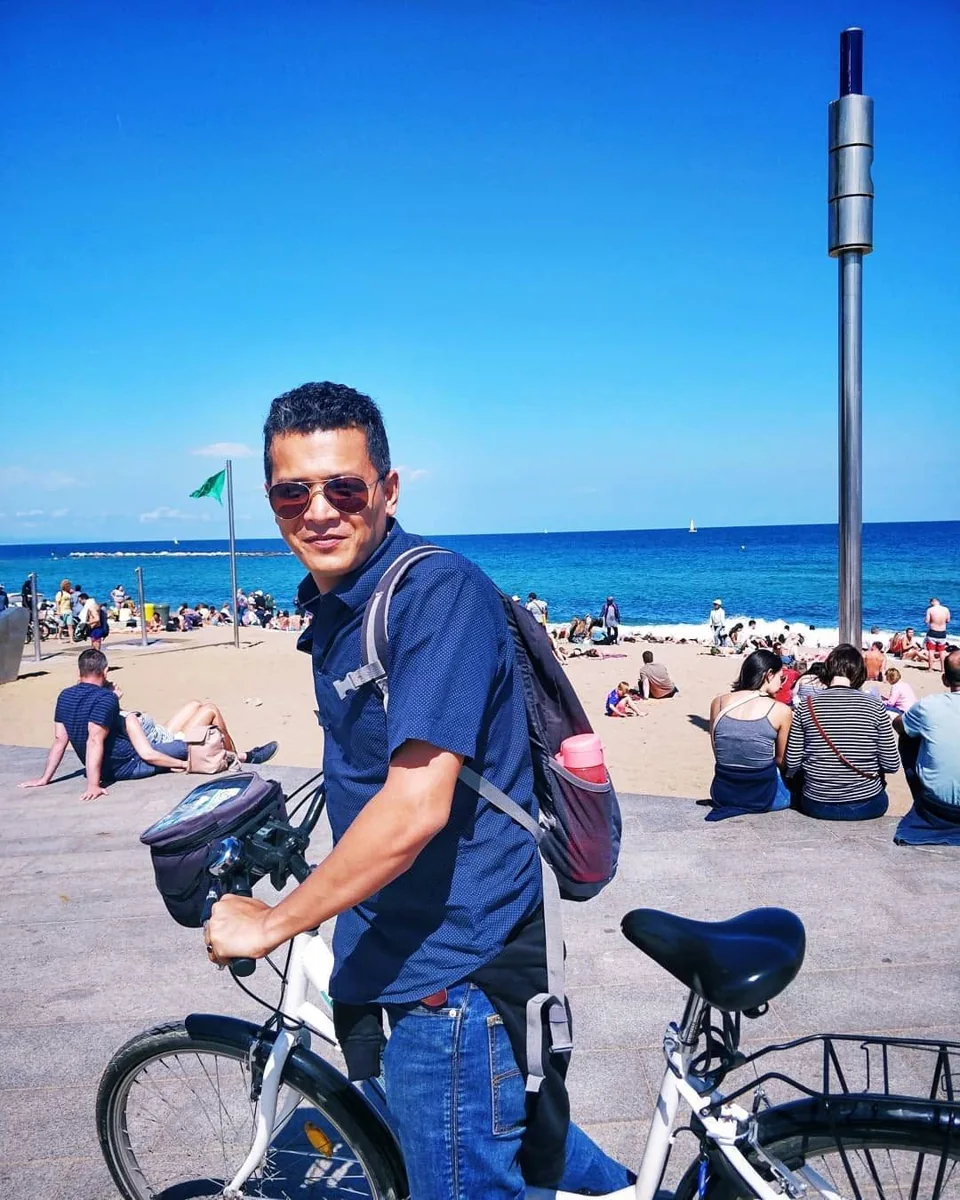 Pranab cycling beside the beach