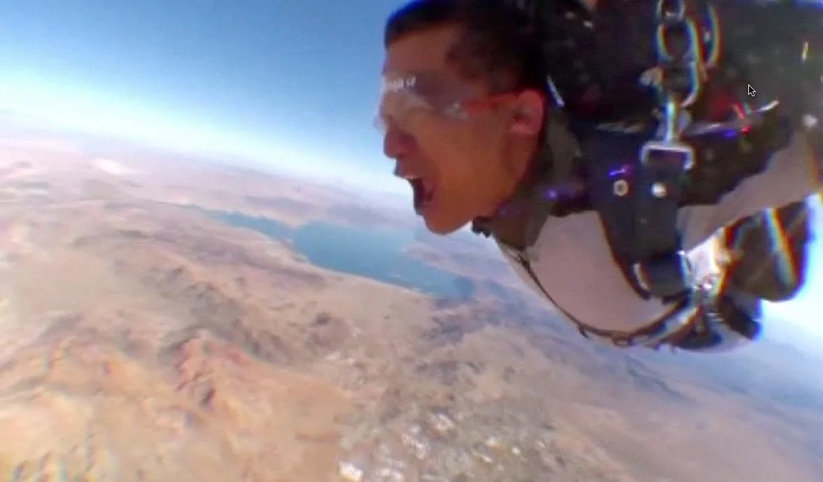 Pranab skydiving over a desert landscape